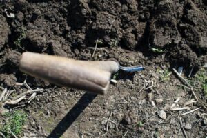 Image of a shovel digging into dirt, representing the process of obtaining a lot loan for home construction.