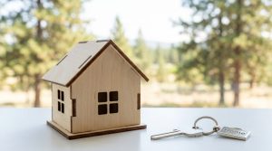 A bright, modern house key with a home keychain, symbolizing successful first-time home buying in Richland, Pasco, Kennewick, Wallowa County, Enterprise, Joseph, and the Northwest.